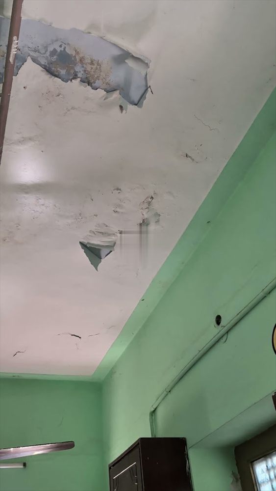 Plaster damaged by damp on a painted wall