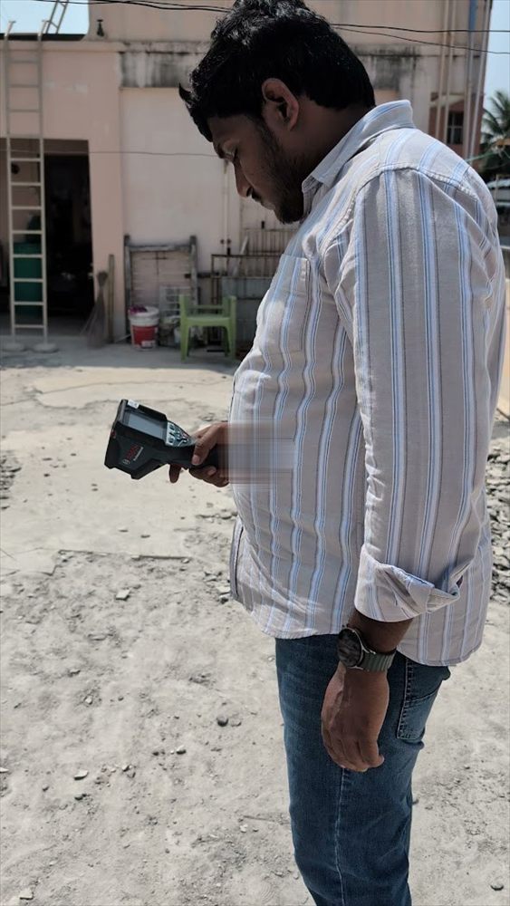 Advanced Damp Check engineer scanning an exterior wall with a moisture detector