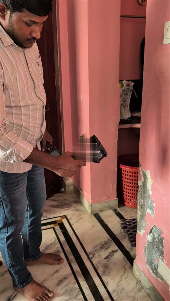 Engineer checking a wall inside a home